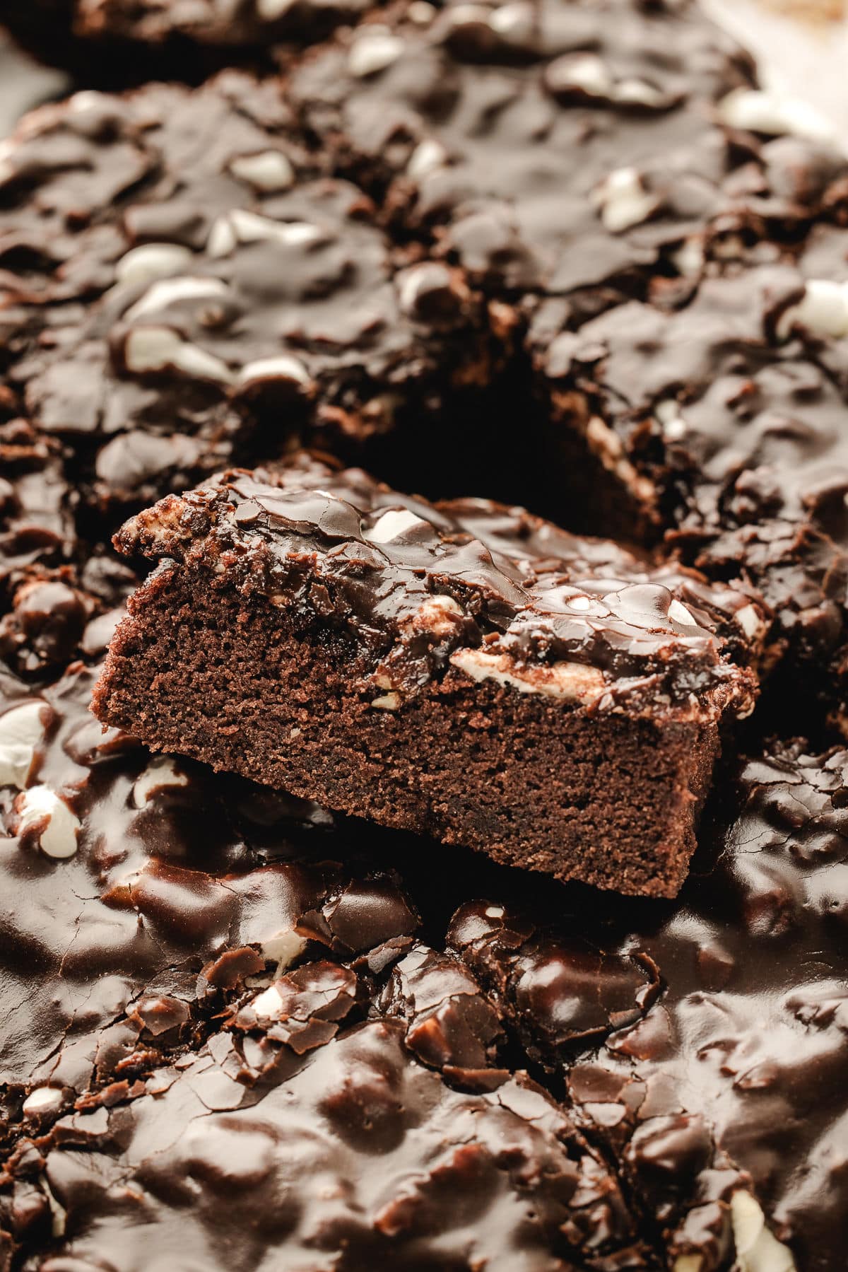 A piece of Mississippi mud cake at an angle in the middle of cut slices.