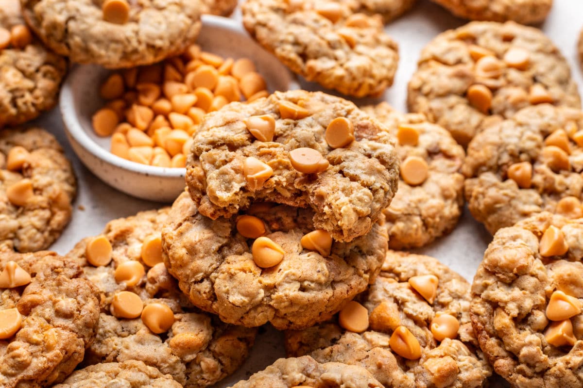 An oatmeal scotchie with a bite missing on top of more cookies.