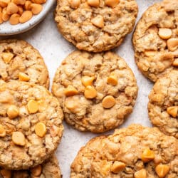 Overlapping oatmeal scotchies next to a dish of butterscotch chips.