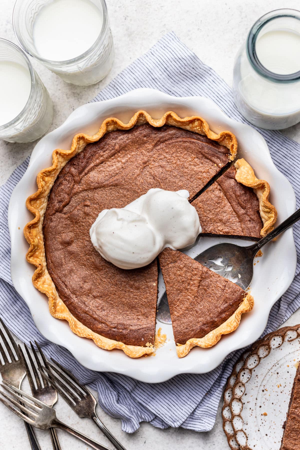 A brownie pie with two scoops of vanilla ice cream on it.