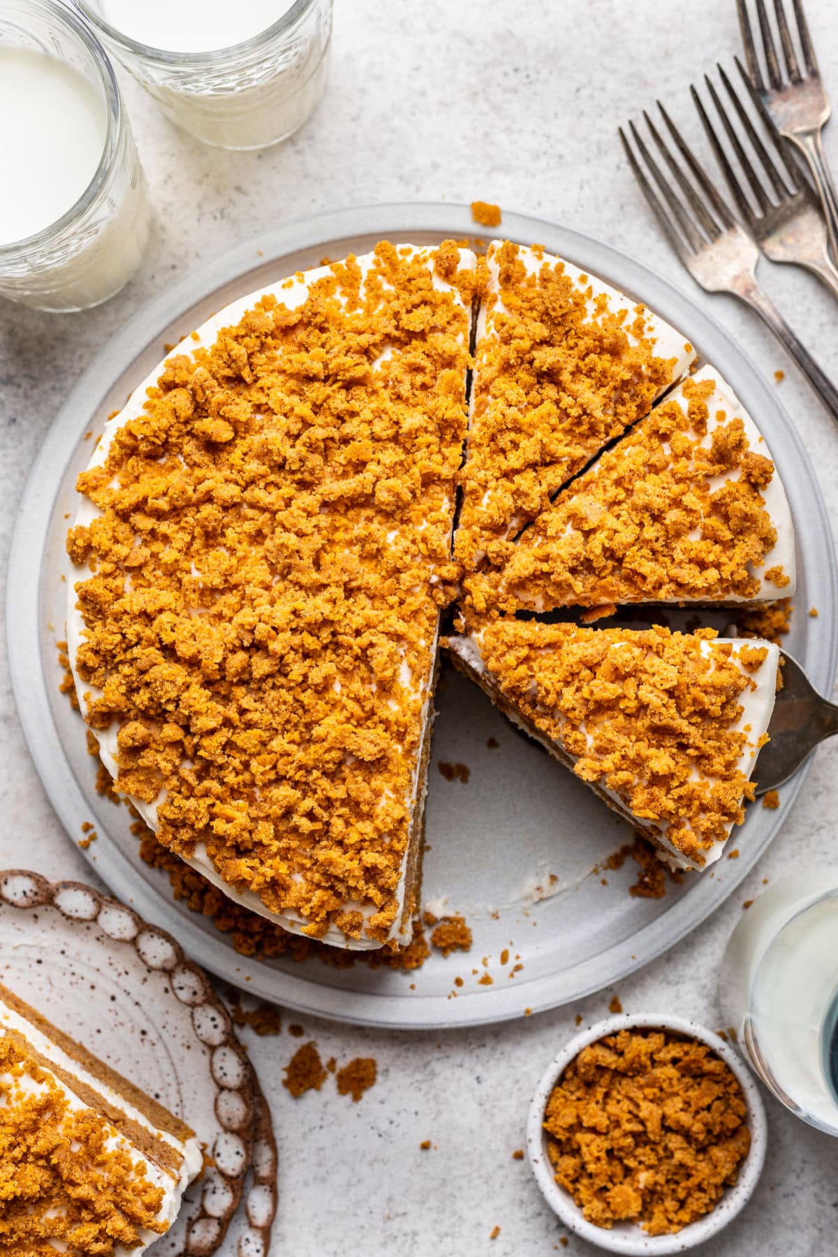A partially sliced pumpkin layer cake on a platter.