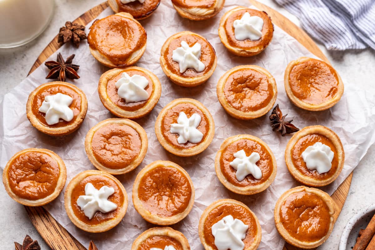 Pumpkin pie tassies on a piece of parchment paper.